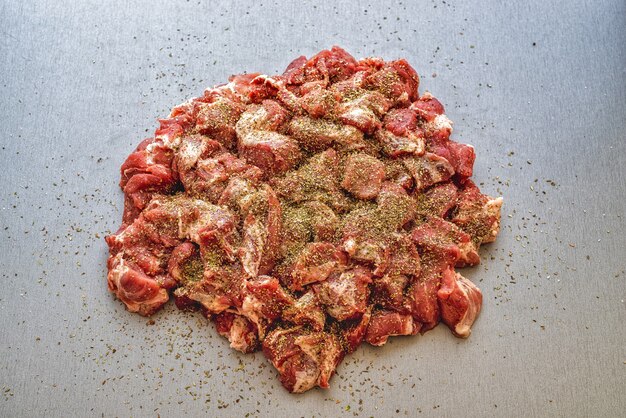 Photo chunks of raw meat on a gray table pork for the grill