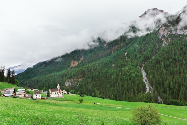 Church on the background of the Alps in Italy