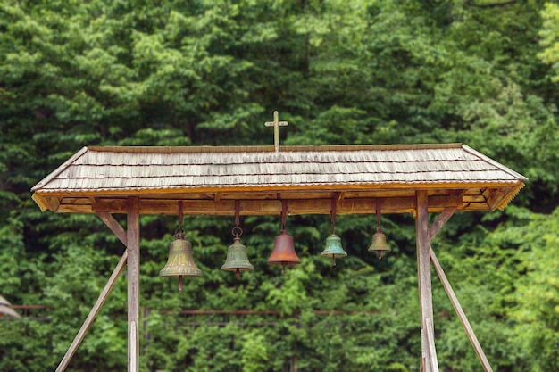 Church bells under a canopy in the courtyard of the church