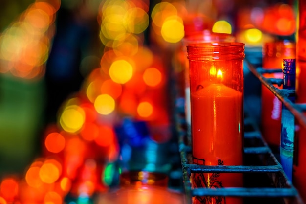 Church candles in transparent chandeliers