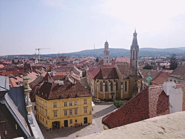 Church and houses in town against clear sky