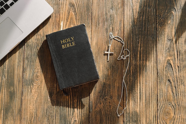 Church online sunday new normal concept bible cell phone and earbuds on a wood background