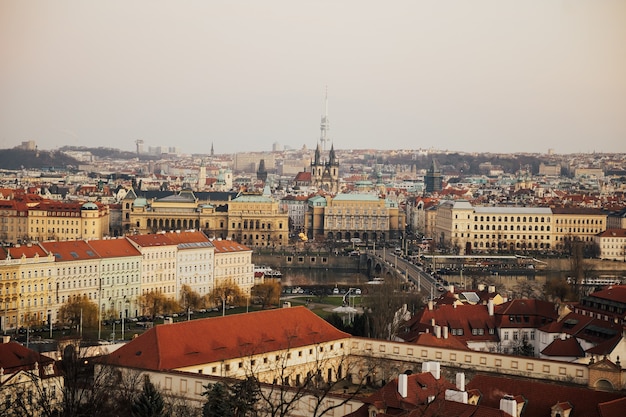 Church and Prague Castle. Red roofs and spires of historical Old Town of Prague.