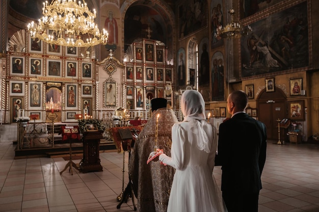 Church of the resurrection vichuga russia may 08 2022 bride and
groom in a christian orthodox church during a wedding ceremony