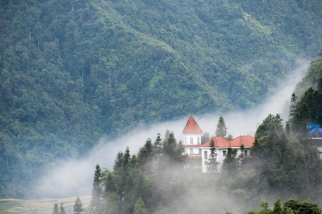 Church in valley on fog in morning at Sapa