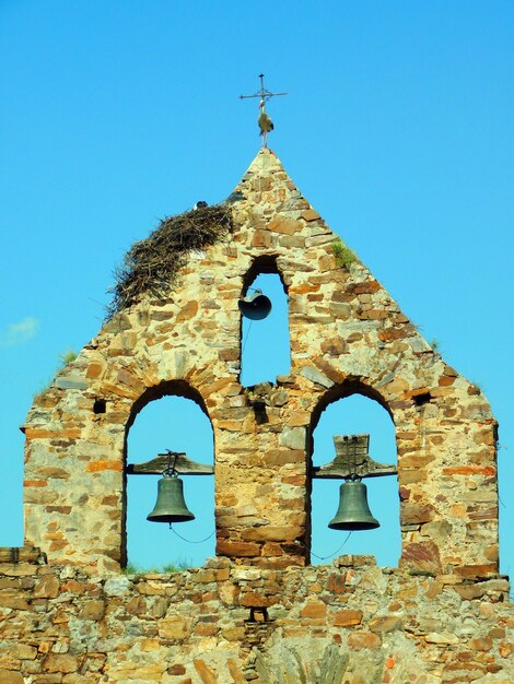 A church with bell tower that says " bell ".