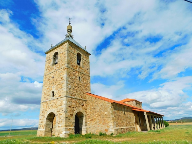 A church with a blue sky and clouds