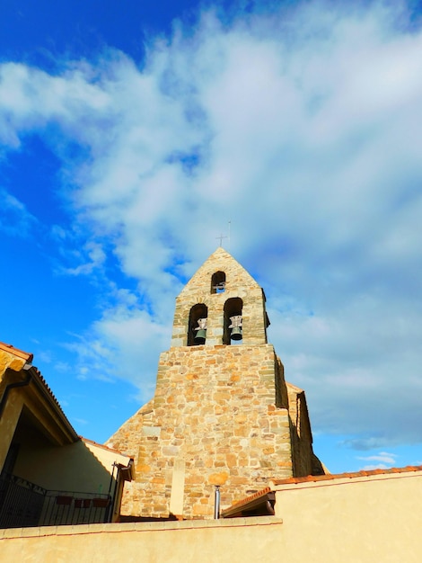 A church with a blue sky and clouds