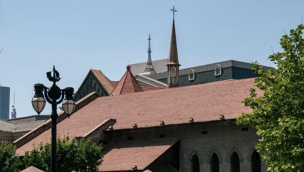 A church with a red roof and a cross on the top