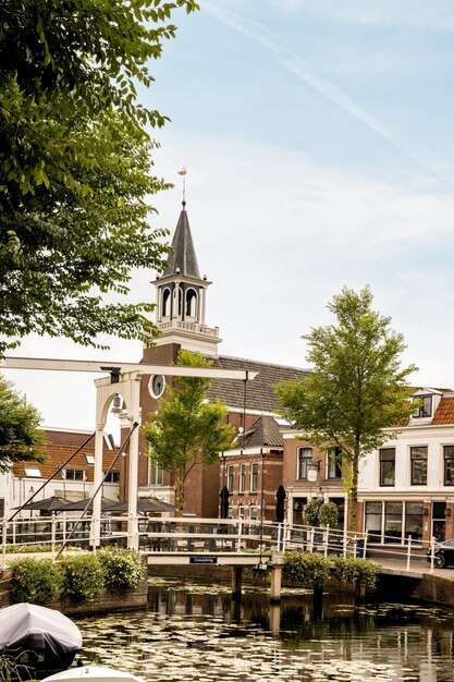 A church with a steeple next to a canal