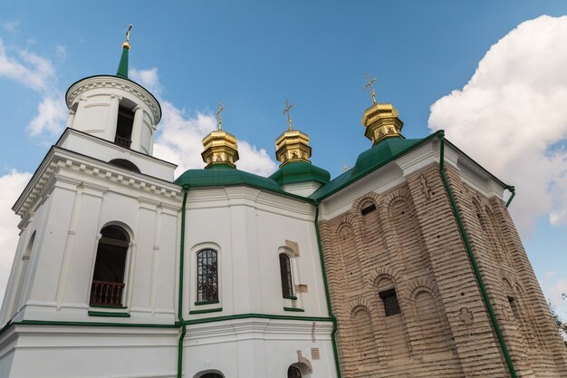 Churches and golden domes in Kyiv, Ukraine. Orthodox Christian Cathedral with golden domes and crosses. Church of the Savior on Berestov, Kiev-Pechersk Lavra.