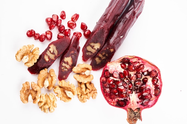 Churchkhela made from pomegranate juice and nuts, Georgian traditional sweets isolated on white