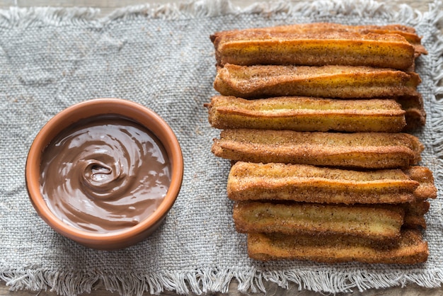 Photo churros - famous spanish dessert with chocolate sauce