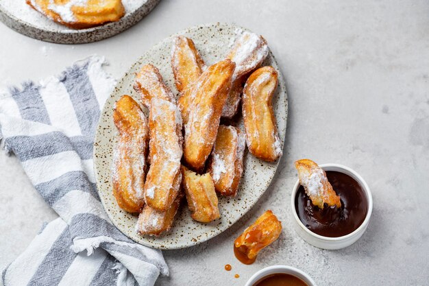 Churros in with caramel and chocolate sauces