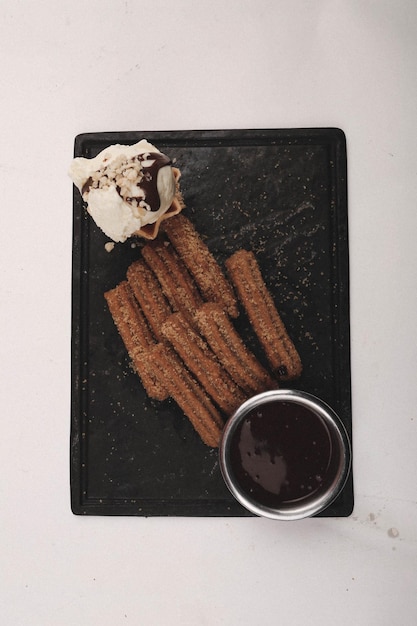 Churros with sugar dipped with chocolate sauce