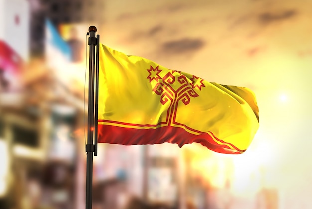 Chuvashia Flag Against City Blurred Background At Sunrise Backlight