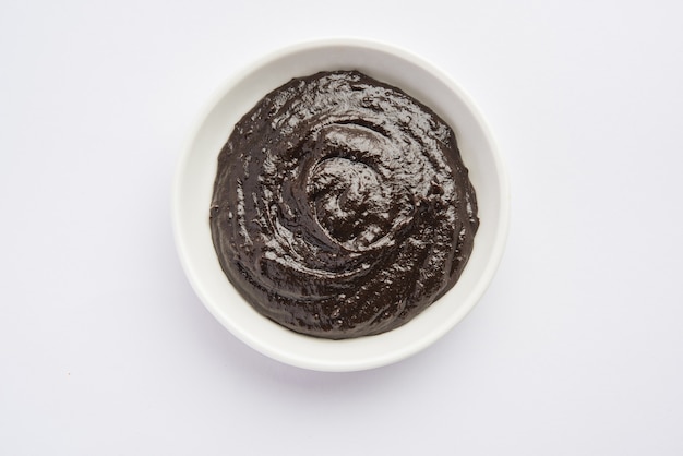 Chyawanprash or Chyavanprash is an Indian Ayurvedic Immunity booster health supplement made up of a concentrated blend of minerals and nutrient-rich herbs, served in a bowl, isolated