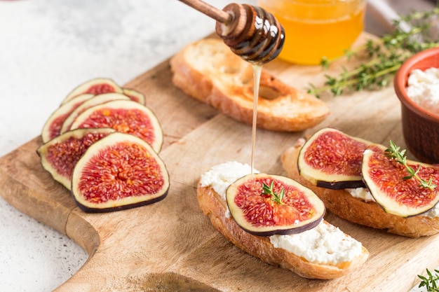 Ciabatta or bruschetta with cottage cheese, figs and honey. sandwich with figs and goat cheese