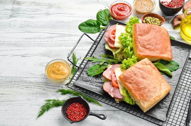 Ciabatta sandwich with bacon tomatoes and cheese Italian food Top view Free copy space