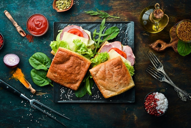 Ciabatta sandwich with bacon tomatoes and cheese Italian food Top view Free copy space