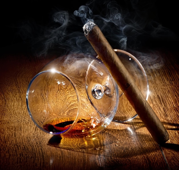 Cigar and almost empty glass of cognac