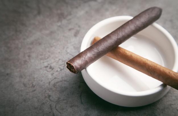 Cigar and ashtray on table