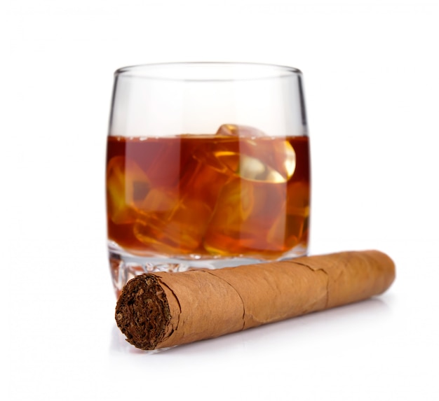 Cigar and glass of whiskey with ice concept isolated