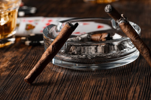 Cigar and playing cards on casino table