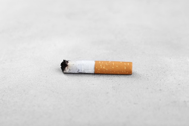 Cigarette butt on light background