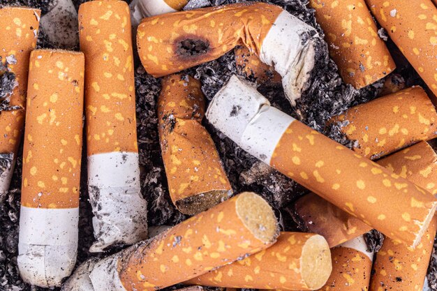 Cigarette butts pile background toxic cancer texture