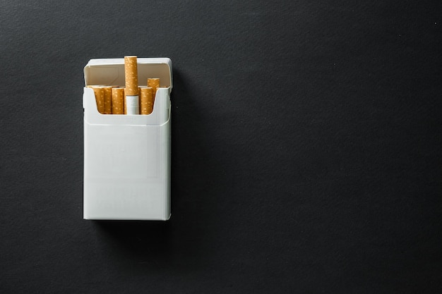 Cigarette on a dark surface. Ashtray. quit Smoking