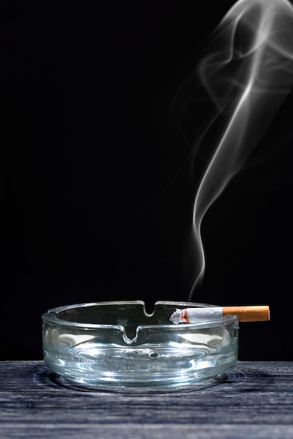 Photo cigarette on transparent ashtray