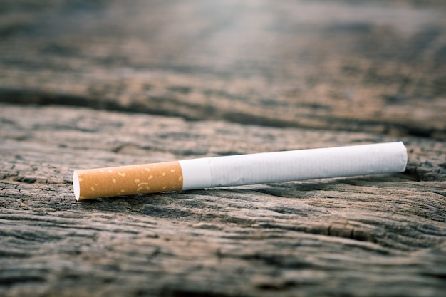 Photo cigarette on a wooden table.ligth and color effect.