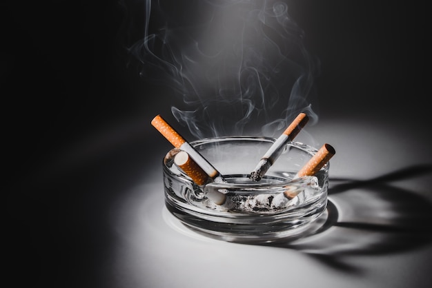 Cigarettes in ashtray spotlight