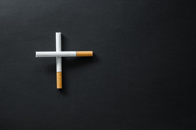 Cigarettes on a dark surface.