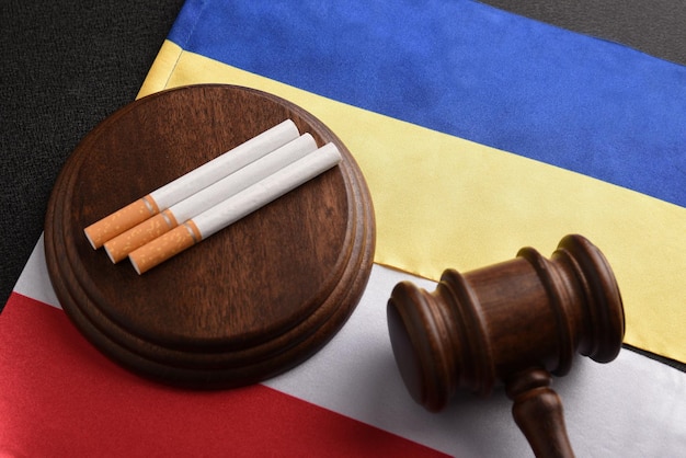 Cigarettes Judge gavel and flag of Ukraine and Poland Cigarette smuggling Illegal import of cigarettes between Poland and Ukraine