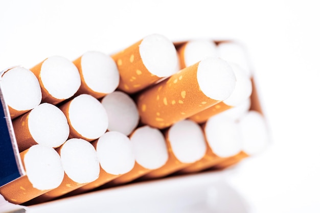 Cigarettes in a pack closeup on white background Smoking tobacco Bad habit