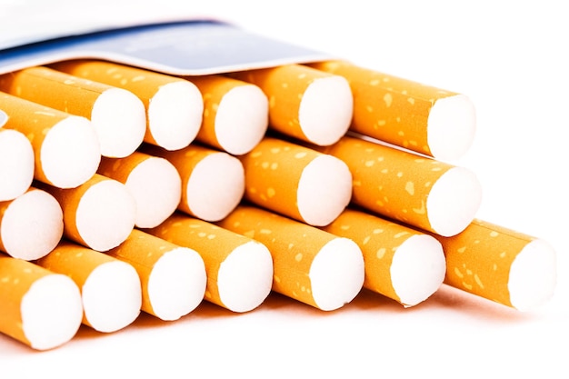 Cigarettes in a pack closeup on white background Smoking tobacco Bad habit