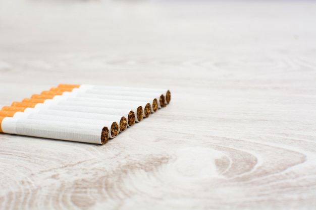 cigarettes on white wooden table copy space