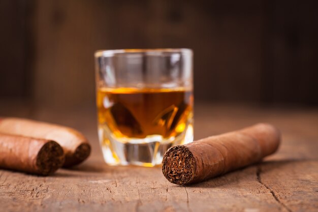 cigars and whisky on old wooden table