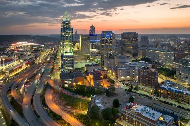 Cincinnati Ohio American city downtown with wide highway crossroads at night Skyscraper buildings over urban transportation infrastructure