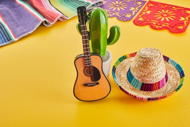 Cinco de mayo holiday background cactus guitar and hat on yellow background