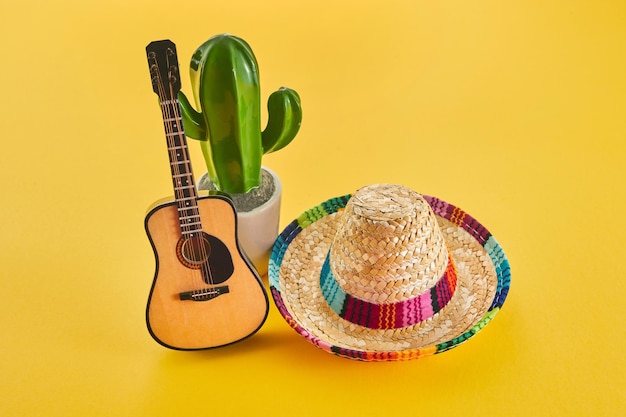Cinco de mayo holiday background cactus guitar and hat on yellow background