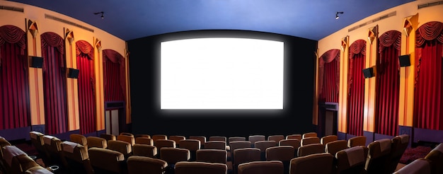 Cinema theater showing empty white movie screen.