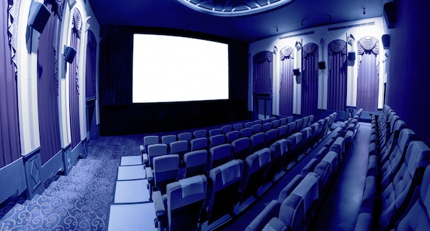 Photo cinema theater showing empty white movie screen.