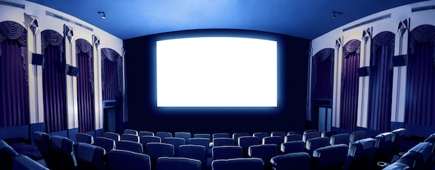 Cinema theater showing empty white movie screen.