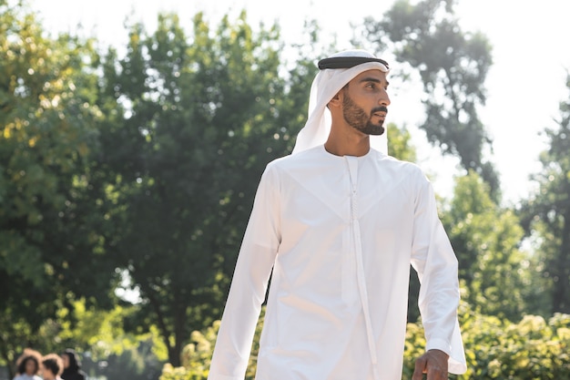 Cinematic image of a man from the emirates spending time in a park