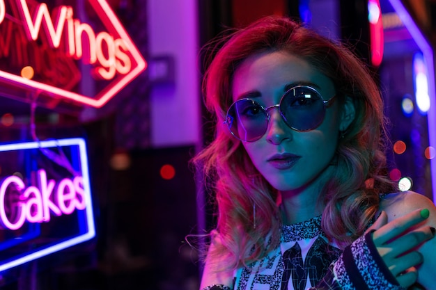 Cinematic night portrait of girl and neon lights