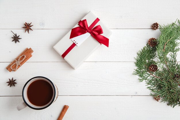 cinnamon,anise stars,fir branches,a Cup of hot chocolate and a box with a gift 