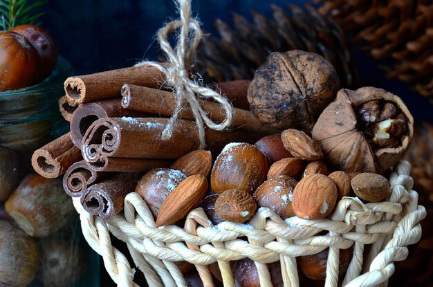 Cinnamon beans walnuts cones acorns on table closeup